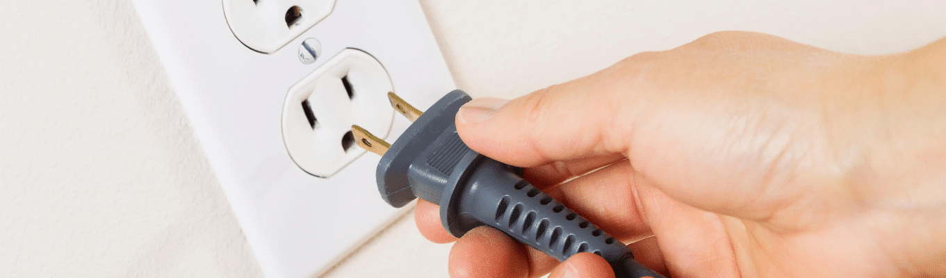 uma mão ligando algo na tomada