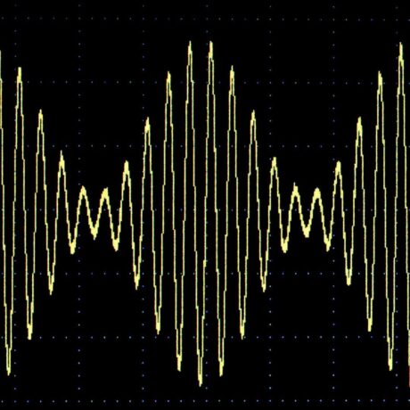 imagem de uma onda senoidal amarela em um fundo preto