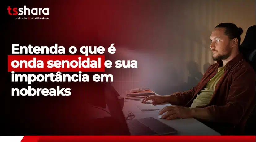 Homem concentrado em frente ao computador com a frase "Entenda o que é onda senoidal e sua importância em nobreaks".