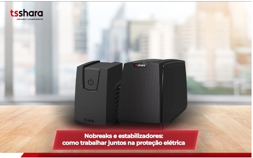 Nobreak e estabilizador da marca TsShara sobre uma mesa, com fundo urbano desfocado.