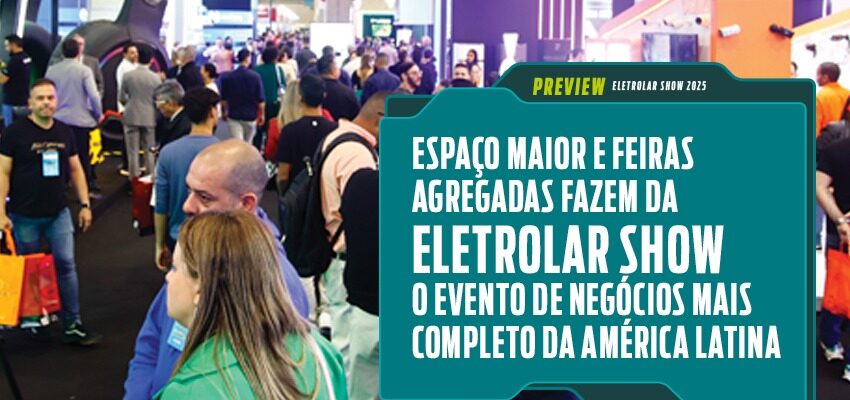 Foto de uma feira de tecnologia movimentada, com muitas pessoas caminhando entre estandes iluminados. Uma placa em destaque anuncia o evento Eletrolar Show, descrito como o maior e mais completo evento de negócios da América Latina