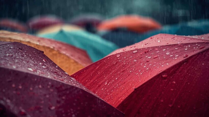 Fotografia em plano médio de um carro elétrico preto sendo carregado em uma estação de recarga ao ar livre durante o entardecer. O cabo de energia está conectado à lateral traseira do veículo, que exibe as lanternas acesas em um tom vermelho vibrante.