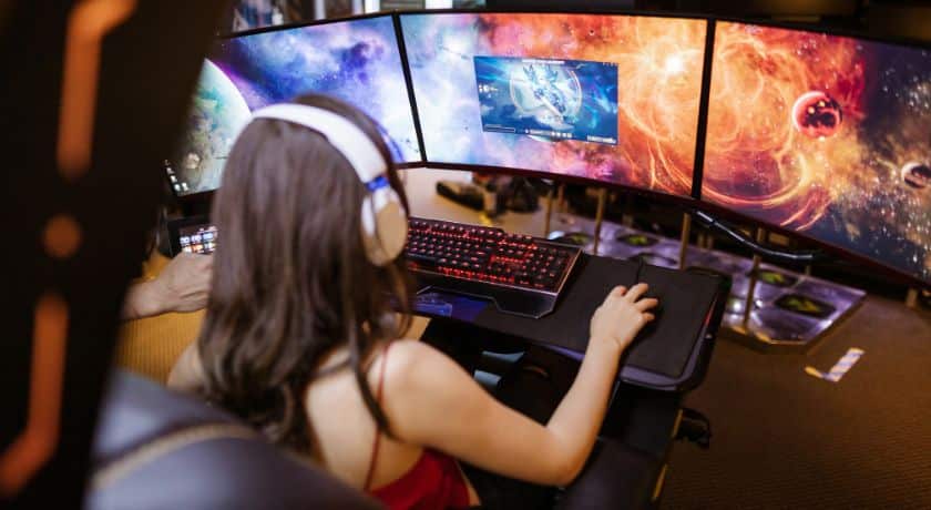 uma menina gamer jogando online com headset
