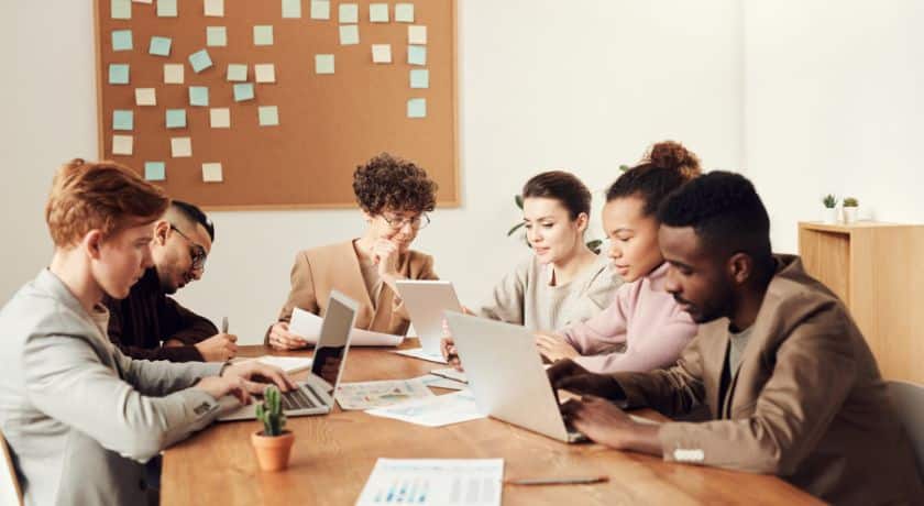 pessoas trabalhando em uma mesa de reunião