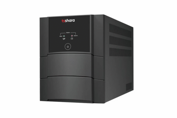A imagem é um recorte de estúdio em fundo branco, mostrando um Nobreak da marca TS Shara. O dispositivo é uma caixa retangular compacta e robusta, de cor preta ou cinza escura. A face frontal tem um design segmentado com detalhes curvos. No painel superior, há o logotipo vermelho "ts shara" e um pequeno painel de controle que inclui: um botão de liga/desliga na parte inferior e indicadores LED (em círculos) para Status, Rede e Bateria.