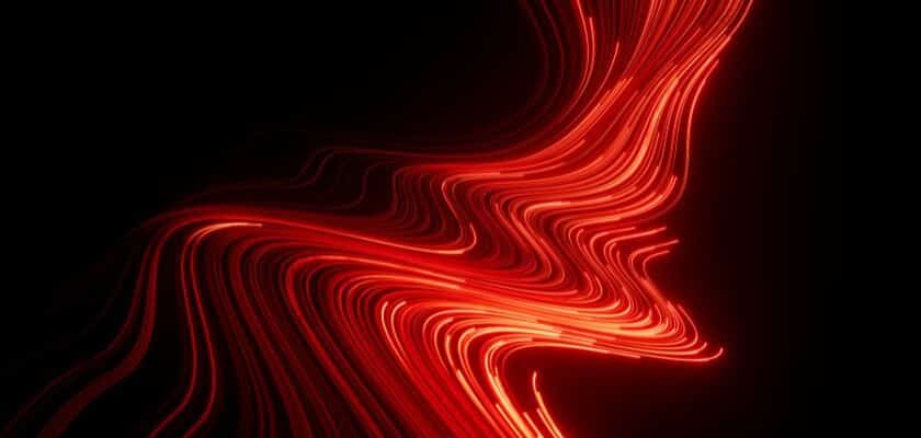 Imagem abstrata com linhas finas e brilhantes de cor vermelha intensa que se movem em ondas e curvas fluidas contra um fundo preto sólido.